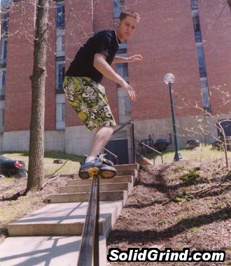 An old school photo of Derek Brooks sliding a handrail at Cornell College