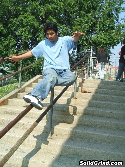 Victor Sierra sticking a Sidewalk on the John Bowne School rail