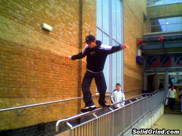 Stuart Pickston doing a cheesegrater on the Chimes shopping centre long rail