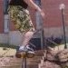 An old school photo of Derek Brooks sliding a handrail at Cornell College