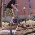An old school photo of Derek Brooks sliding a handrail at Cornell College